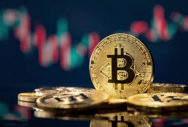 Golden bitcoin coin over defocused stock chart with copy space, Olsztyn, Poland 13 July 2021